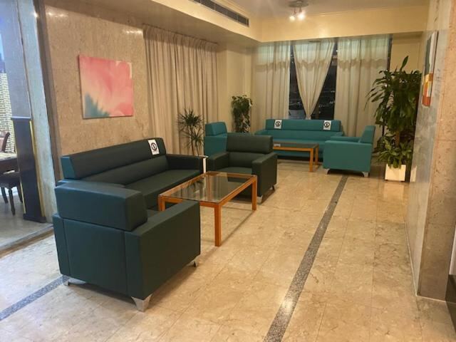 Lobby seating area with green sofas